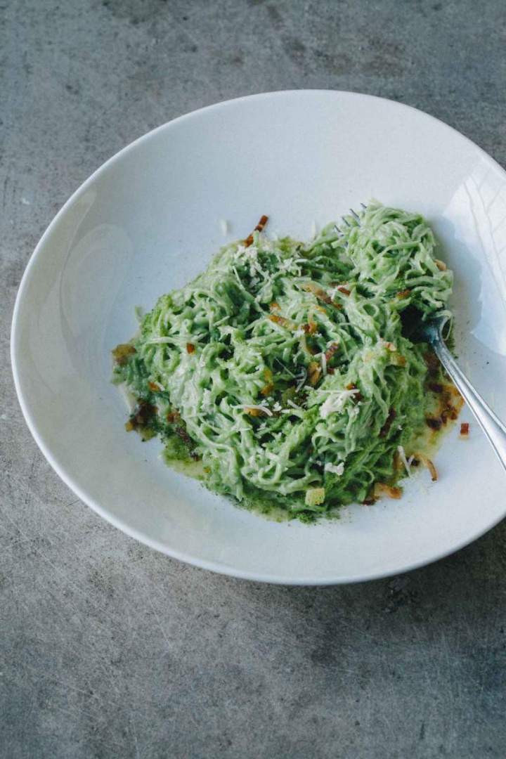 Wild garlic pasta with pancetta and green breadcrumbs served in a bowl