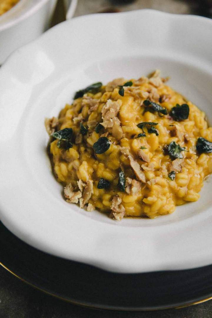 Chestnut and squash risotto served in a bowl with crispy sage