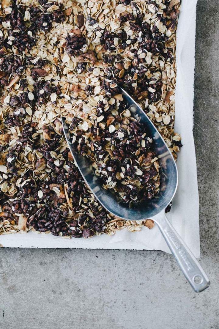 Dark chocolate granola with rice puffs on a baking sheet