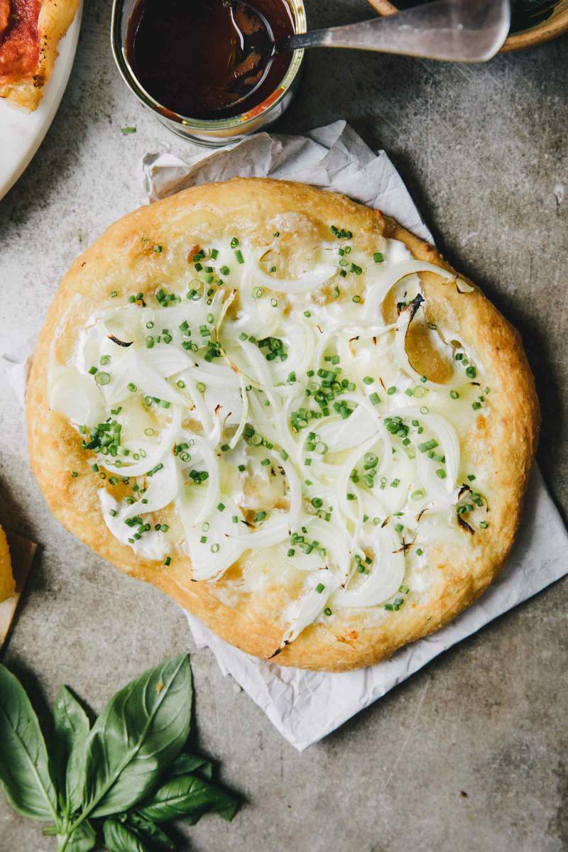 Fried pizza with sour cream, mozzarella cheese, onion and chives
