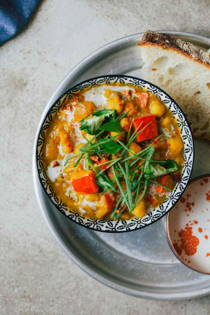 Squash and chickpeas curry served with yogurt