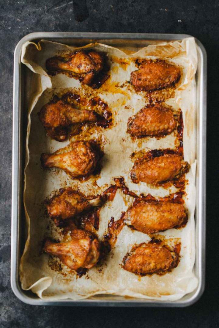Baked spicy chicken wings with spices in a baking dish